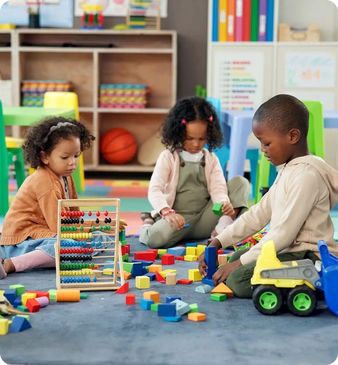 Children playing with toys in classroom.